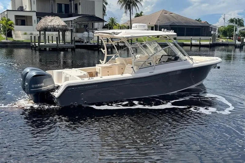  Yacht Photos Pics 2020 Grady-White Freedom 285 boat on water, featuring Yamaha engines, near waterfront homes.