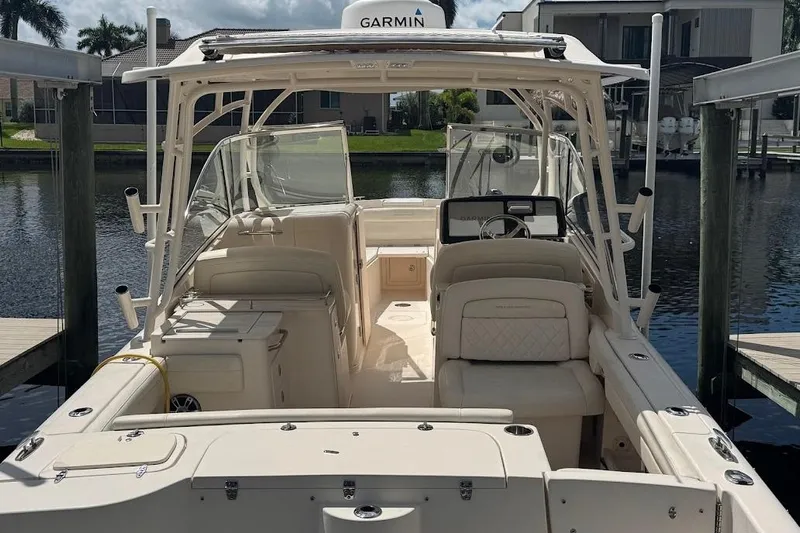  Yacht Photos Pics 2020 Grady-White Freedom 285 boat docked, featuring spacious seating and Garmin navigation.