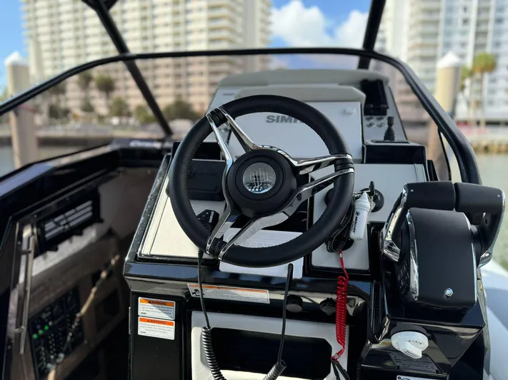  Yacht Photos Pics 2025 Ranieri CAYMAN 38.0 EXECUTIVE boat helm with modern controls and cityscape background.