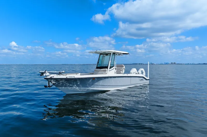  Yacht Photos Pics 2025 Boston Whaler 280 Dauntless boat on calm ocean under blue sky.