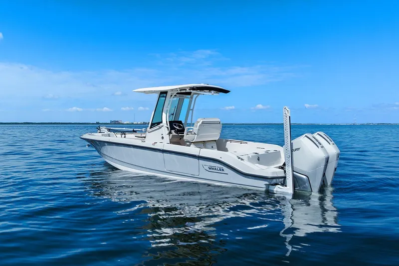 Yacht Photos Pics 2025 Boston Whaler 280 Dauntless boat on calm blue water under clear sky.