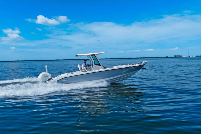  Yacht Photos Pics 2025 Boston Whaler 280 Dauntless cruising on open water under a clear blue sky.