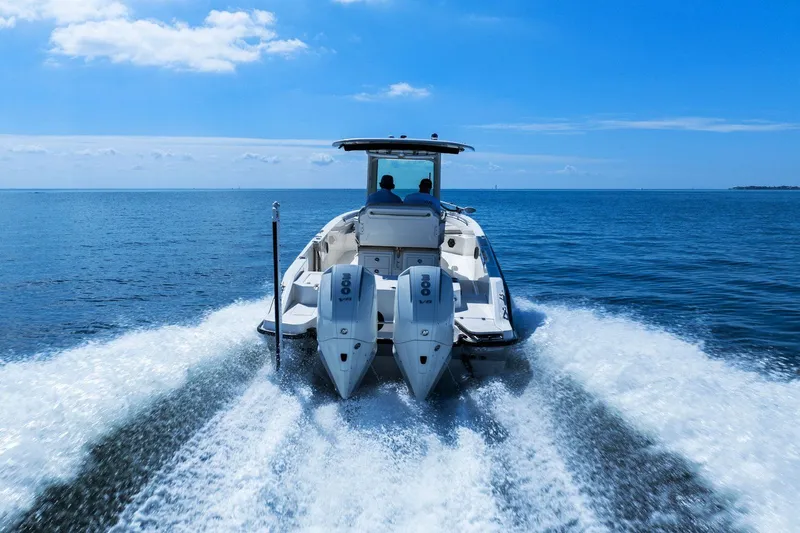  Yacht Photos Pics 2025 Boston Whaler 280 Dauntless cruising on open water, rear view.
