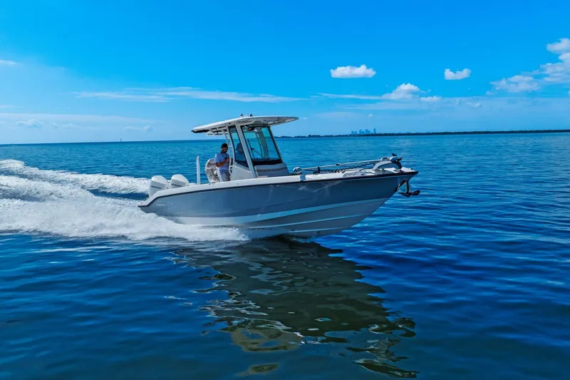  Yacht Photos Pics 2025 Boston Whaler 280 Dauntless cruising on open water under clear blue skies.