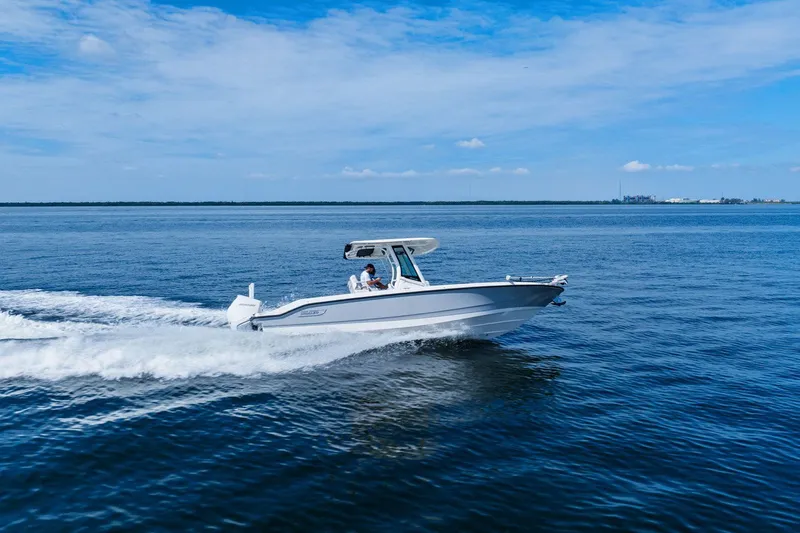  Yacht Photos Pics 2025 Boston Whaler 280 Dauntless cruising on open water under a clear blue sky.