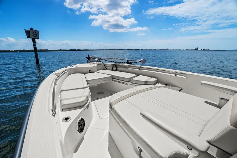  Yacht Photos Pics 2025 Boston Whaler 280 Dauntless boat on calm water under blue sky.
