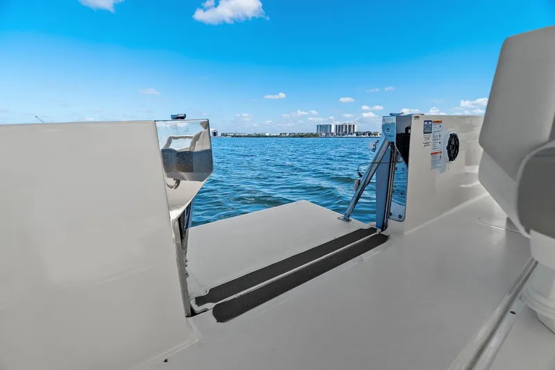  Yacht Photos Pics 2025 Boston Whaler 280 Dauntless boat deck with ocean view and city skyline.