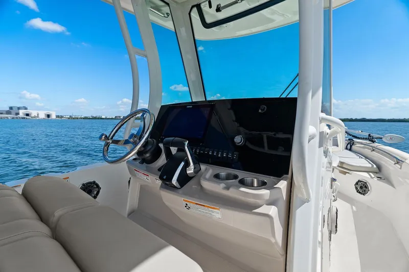  Yacht Photos Pics 2025 Boston Whaler 280 Dauntless helm with modern controls and ocean view.