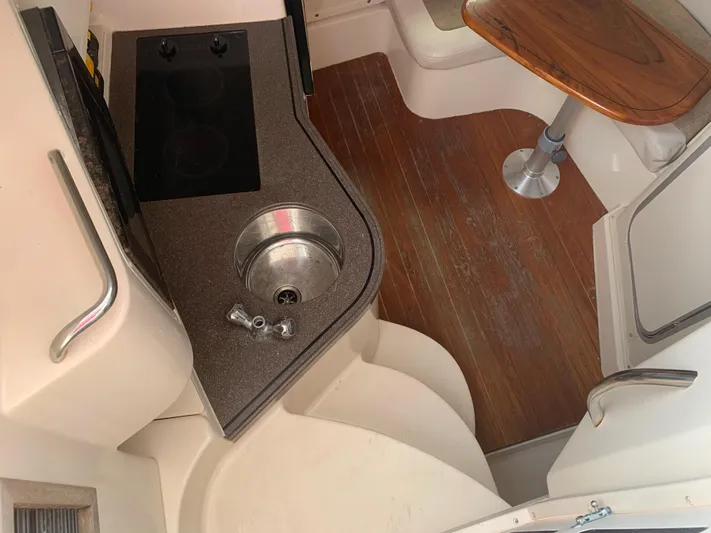  Yacht Photos Pics 2001 Grady-White 330 Express boat interior with kitchenette and seating area.