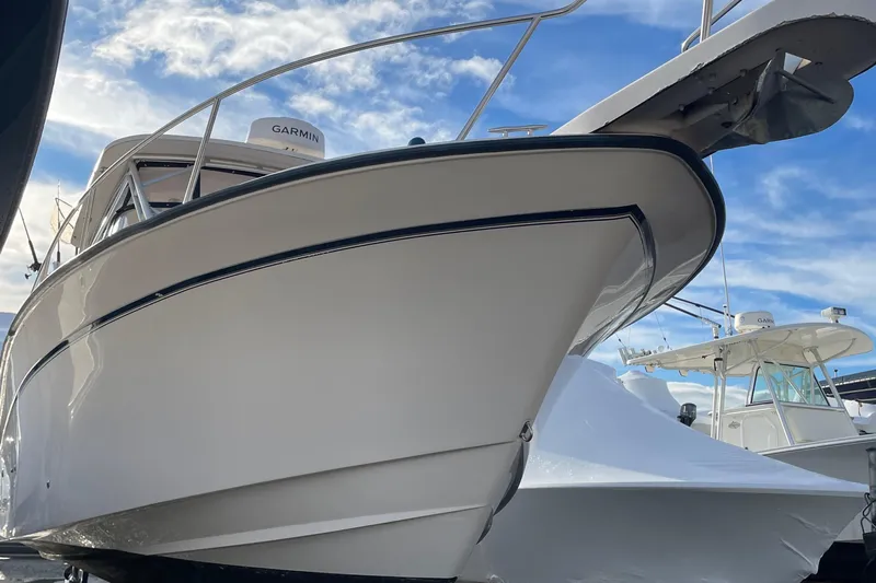  Yacht Photos Pics 2001 Grady-White 330 Express boat with Garmin equipment under a blue sky.