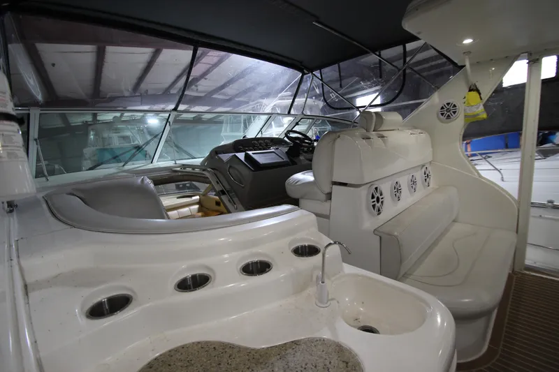  Yacht Photos Pics 2003 Cruisers Yachts 4450 Express Motoryacht interior with helm and seating area.