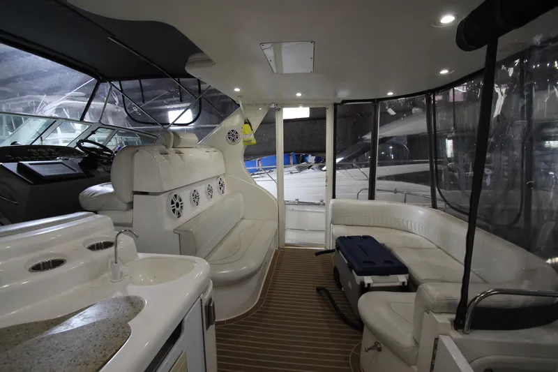  Yacht Photos Pics Luxurious interior of 2003 Cruisers Yachts 4450 Express Motoryacht with seating and helm.