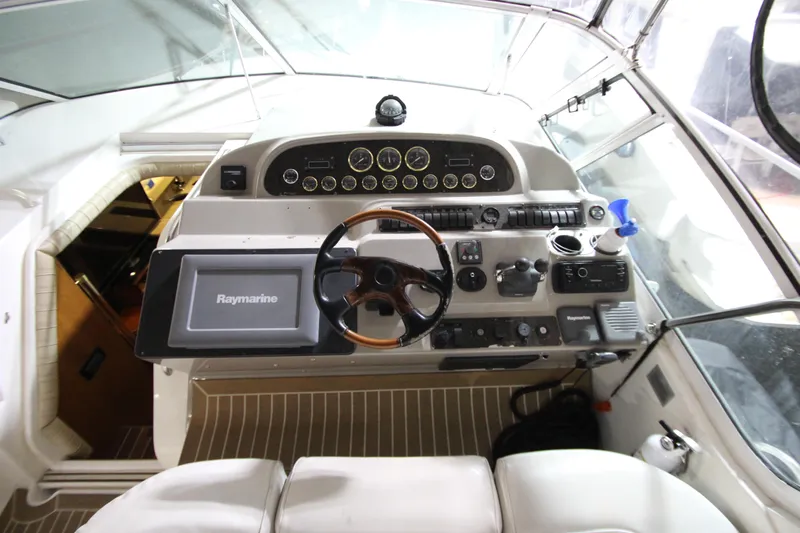  Yacht Photos Pics 2003 Cruisers Yachts 4450 Express Motoryacht helm with Raymarine navigation system.