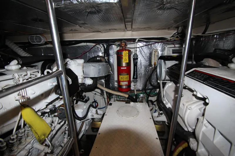  Yacht Photos Pics Engine room of 2003 Cruisers Yachts 4450 Express Motoryacht with visible fire extinguisher.