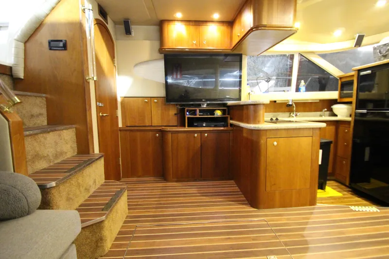  Yacht Photos Pics Luxurious interior of 2003 Cruisers Yachts 4450 Express Motoryacht with wood cabinetry and modern amenities.