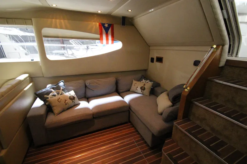  Yacht Photos Pics Luxurious interior of 2003 Cruisers Yachts 4450 Express Motoryacht with cozy seating and nautical decor.