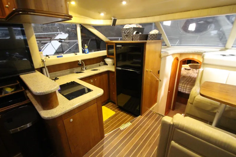  Yacht Photos Pics Luxurious 2003 Cruisers Yachts 4450 Express Motoryacht interior with modern kitchen and cozy seating.