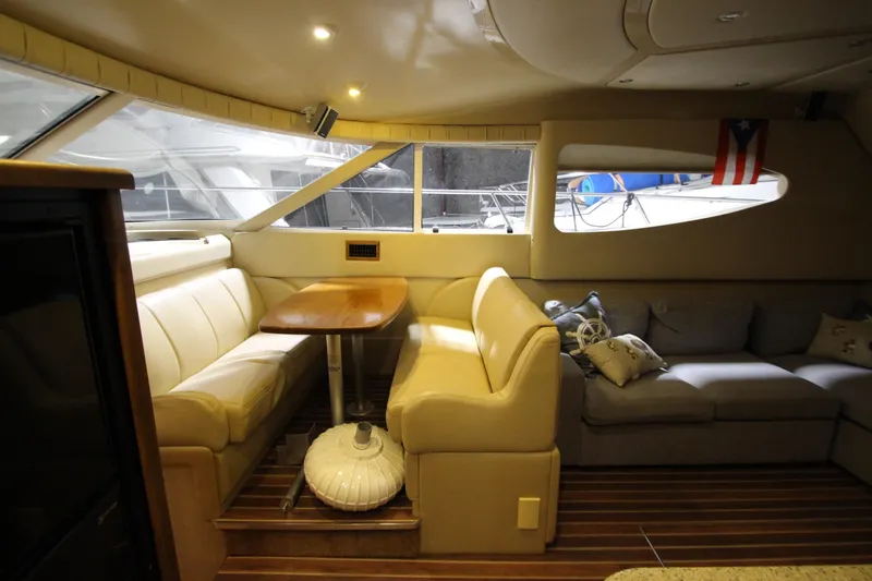  Yacht Photos Pics Luxurious interior of 2003 Cruisers Yachts 4450 Express Motoryacht with elegant seating and table.