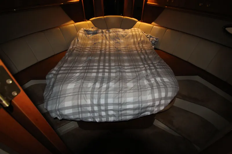  Yacht Photos Pics 2003 Cruisers Yachts 4450 Express Motoryacht cabin with cozy bed and ambient lighting.