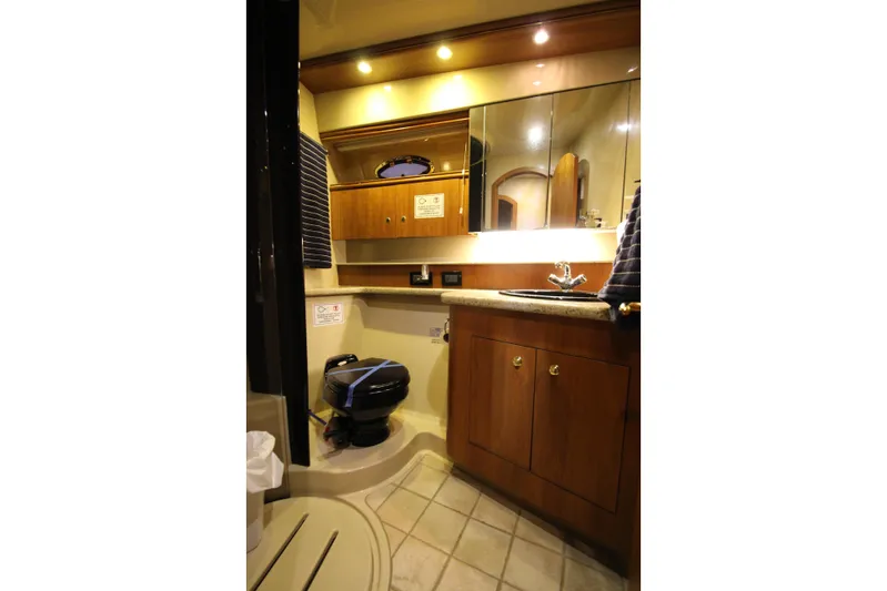 Yacht Photos Pics Luxurious bathroom in 2003 Cruisers Yachts 4450 Express Motoryacht with wood cabinetry.