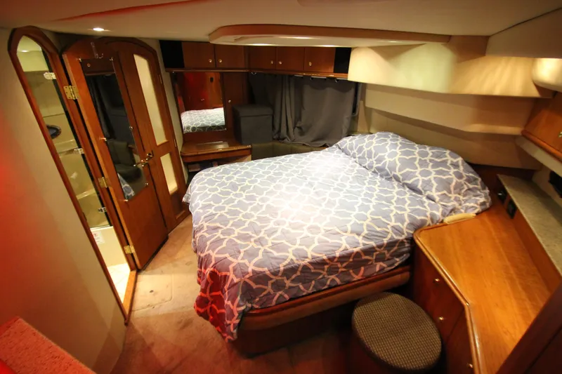  Yacht Photos Pics Luxurious bedroom interior of 2003 Cruisers Yachts 4450 Express Motoryacht with elegant wood finishes.