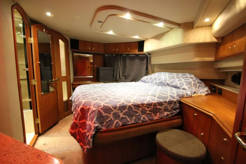  Yacht Photos Pics Luxurious bedroom interior of 2003 Cruisers Yachts 4450 Express Motoryacht with wood accents.