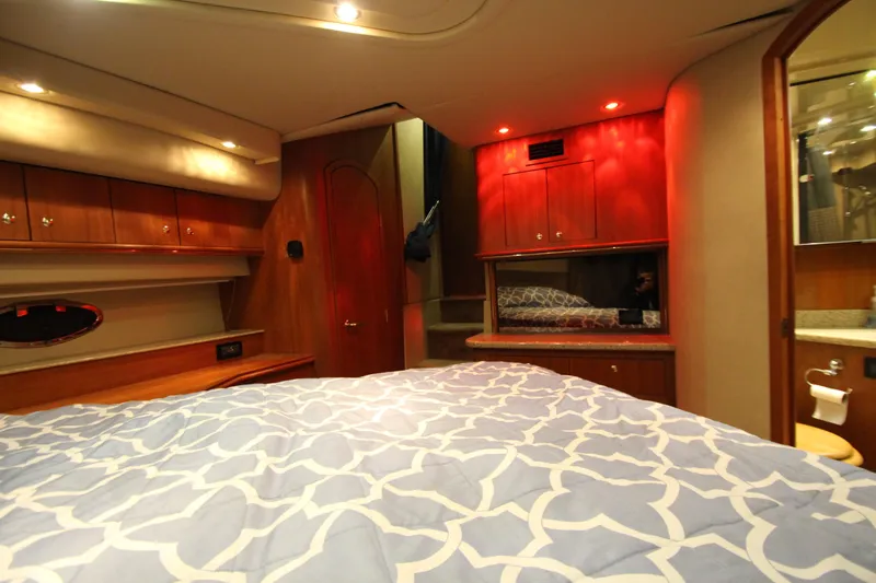  Yacht Photos Pics Luxurious 2003 Cruisers Yachts 4450 Express Motoryacht bedroom interior with elegant wood finishes.