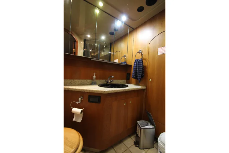  Yacht Photos Pics Luxurious bathroom in 2003 Cruisers Yachts 4450 Express Motoryacht with wood cabinetry.