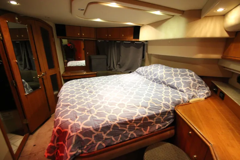  Yacht Photos Pics Luxurious bedroom interior of 2003 Cruisers Yachts 4450 Express Motoryacht with elegant wood finishes.