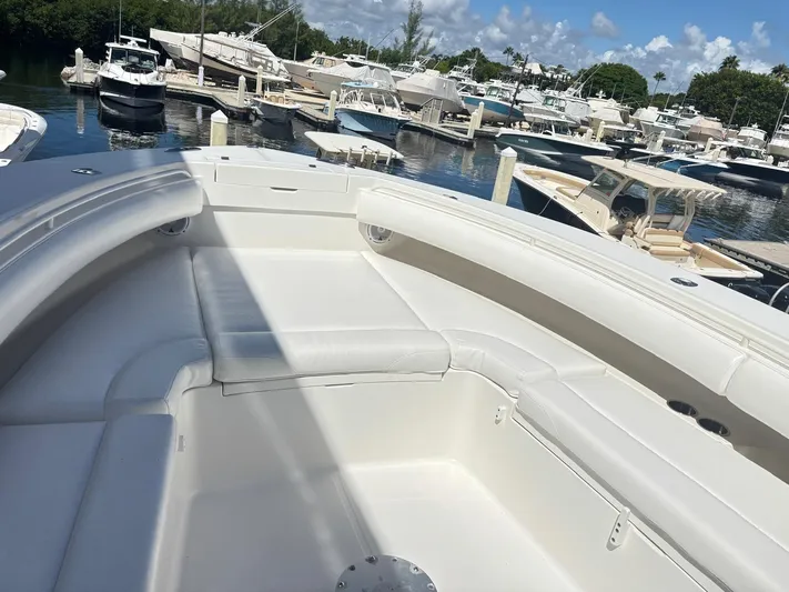  Yacht Photos Pics 2015 Regulator 34 CC boat with white seating, docked in a marina.