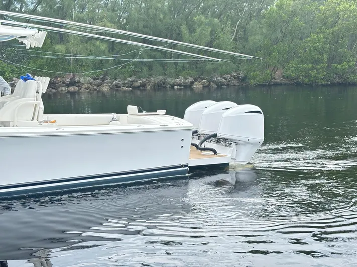  Yacht Photos Pics 2015 Regulator 34 CC boat with triple engines on calm water.