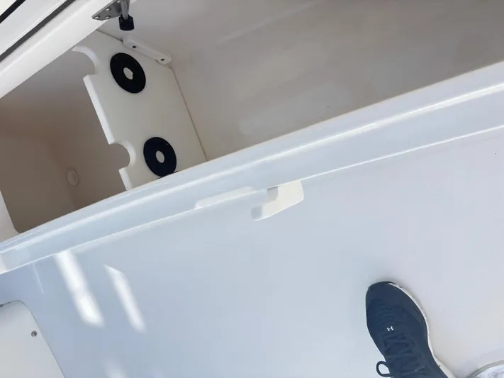  Yacht Photos Pics Open storage compartment on 2015 Regulator 34 CC boat with visible foot.