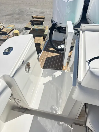  Yacht Photos Pics 2015 Regulator 34 CC boat deck with open hatch and visible engine area.