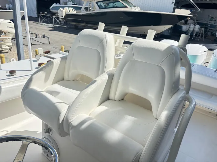  Yacht Photos Pics 2015 Regulator 34 CC boat with white cushioned seats and steering wheel.