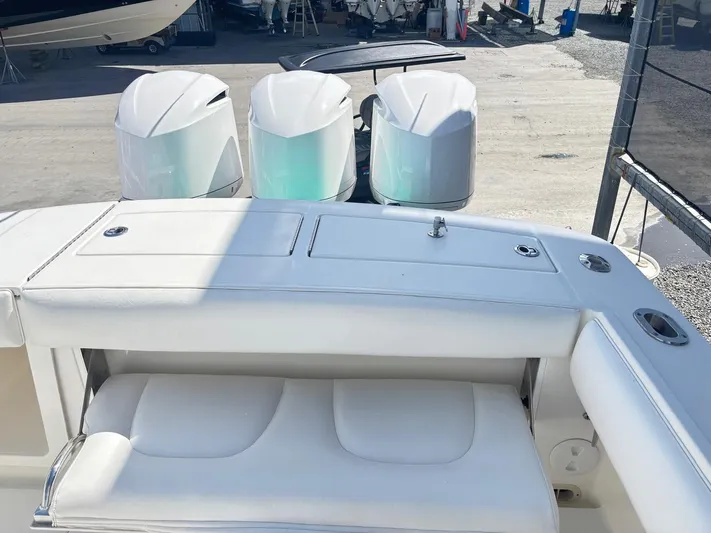  Yacht Photos Pics 2015 Regulator 34 CC boat with triple outboard engines and white seating.