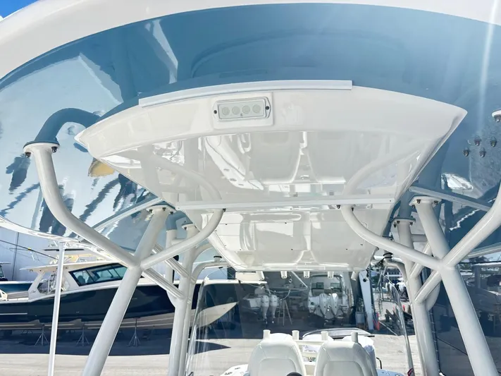  Yacht Photos Pics 2015 Regulator 34 CC boat with blue and white T-top structure.