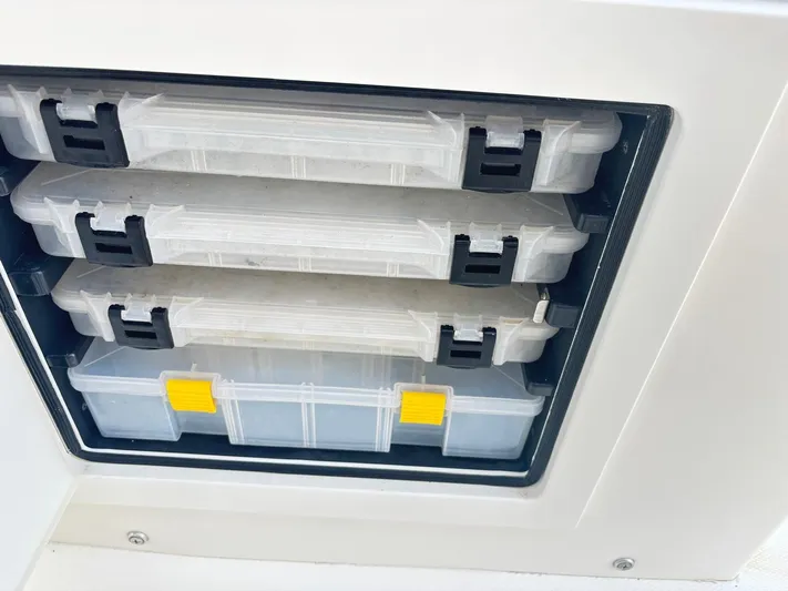  Yacht Photos Pics Storage compartments on a 2015 Regulator 34 CC boat, featuring organized tackle boxes.