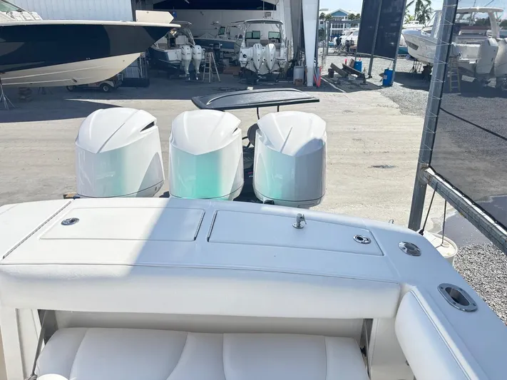  Yacht Photos Pics 2015 Regulator 34 CC boat with triple outboard engines in a marina setting.
