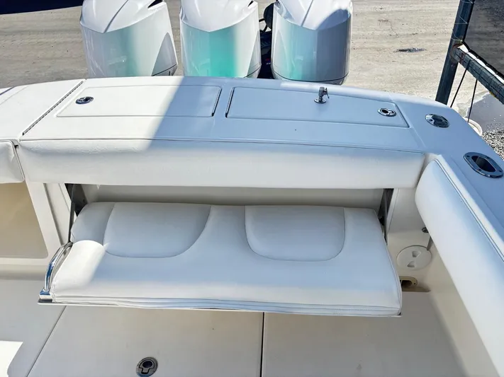  Yacht Photos Pics 2015 Regulator 34 CC boat with white cushioned seating and dual outboard engines.