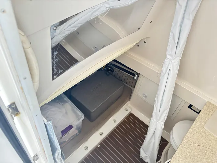  Yacht Photos Pics Interior cabin of 2015 Regulator 34 CC boat with storage and seating area.