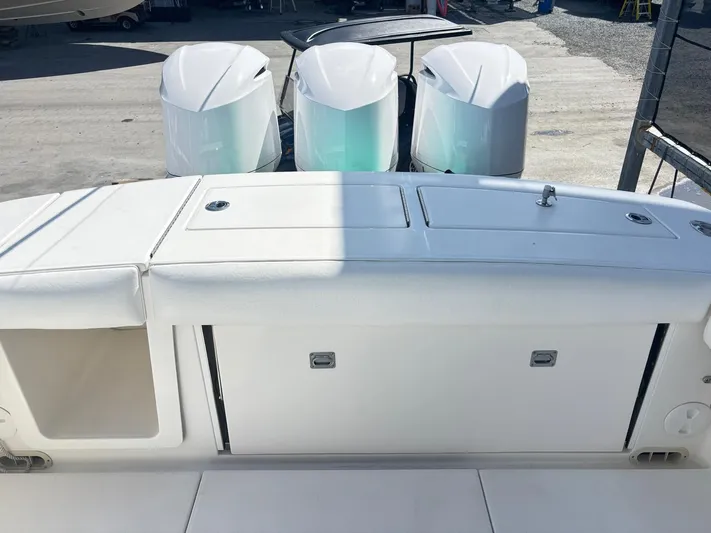  Yacht Photos Pics 2015 Regulator 34 CC boat with triple outboard engines, docked on a sunny day.