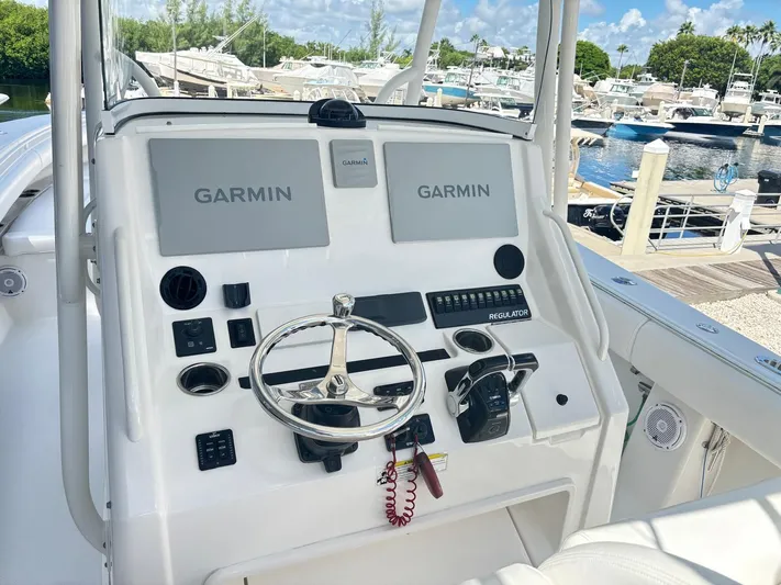  Yacht Photos Pics 2015 Regulator 34 CC boat console with Garmin navigation, docked at marina.