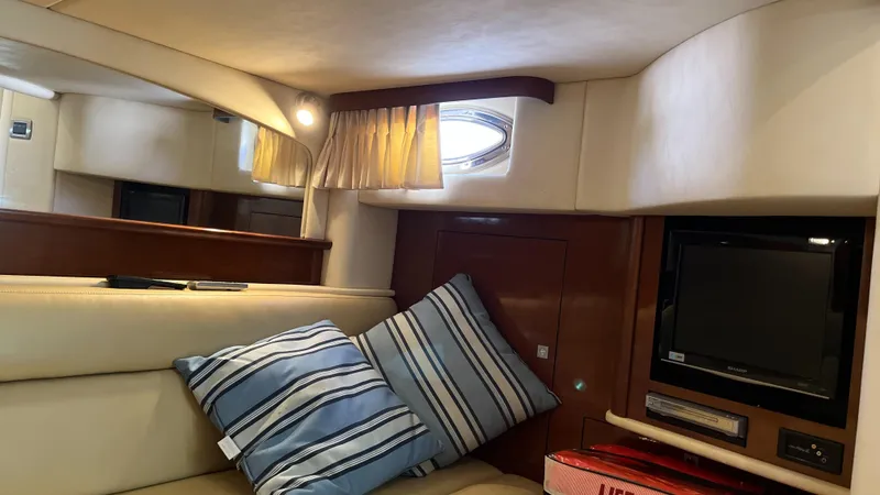 Lowest Price In Usa Yacht Photos Pics Interior of 2008 Sea Ray 44 Sundancer with cozy seating, striped pillows, and a small TV.