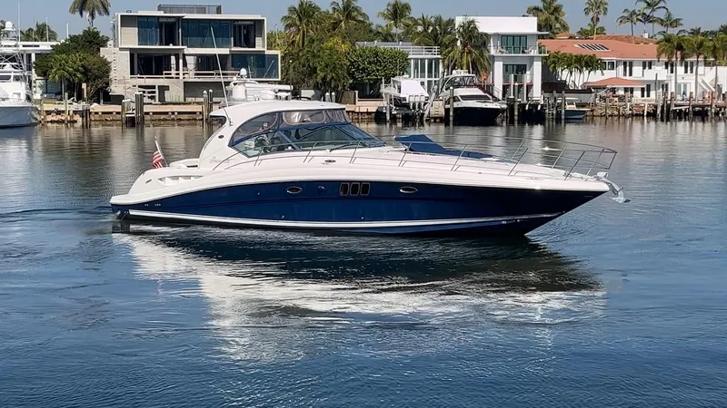 Lowest Price In Usa Yacht Photos Pics 2008 Sea Ray 44 Sundancer yacht cruising in a serene waterfront setting.