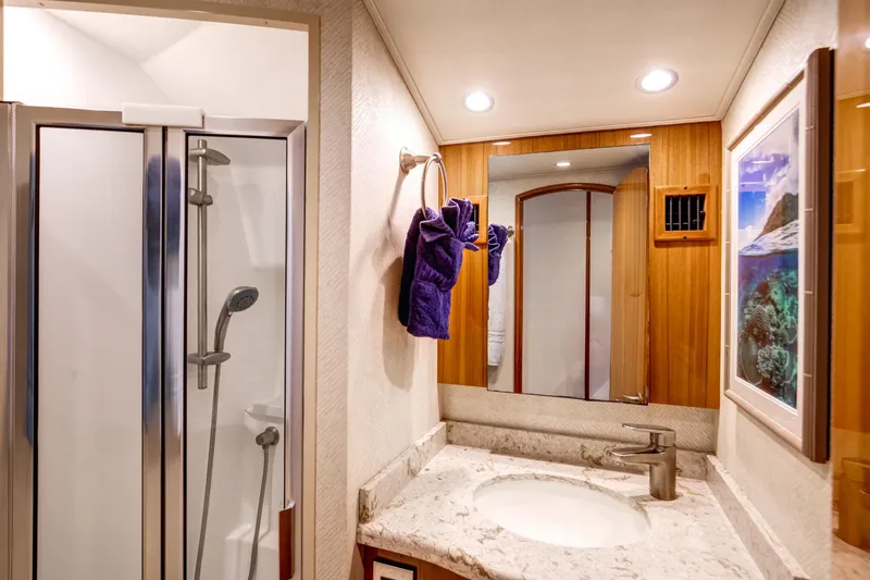 Dorothy Marie Yacht Photos Pics Luxurious bathroom in 2017 Viking 48 Convertible yacht with modern shower and elegant fixtures.