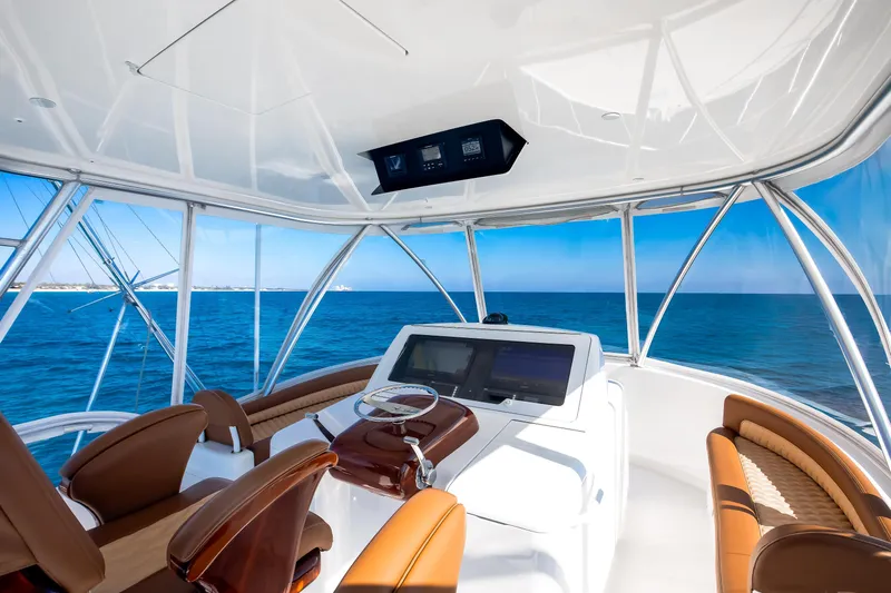 Dorothy Marie Yacht Photos Pics Interior view of 2017 Viking 48 Convertible yacht helm with ocean backdrop.