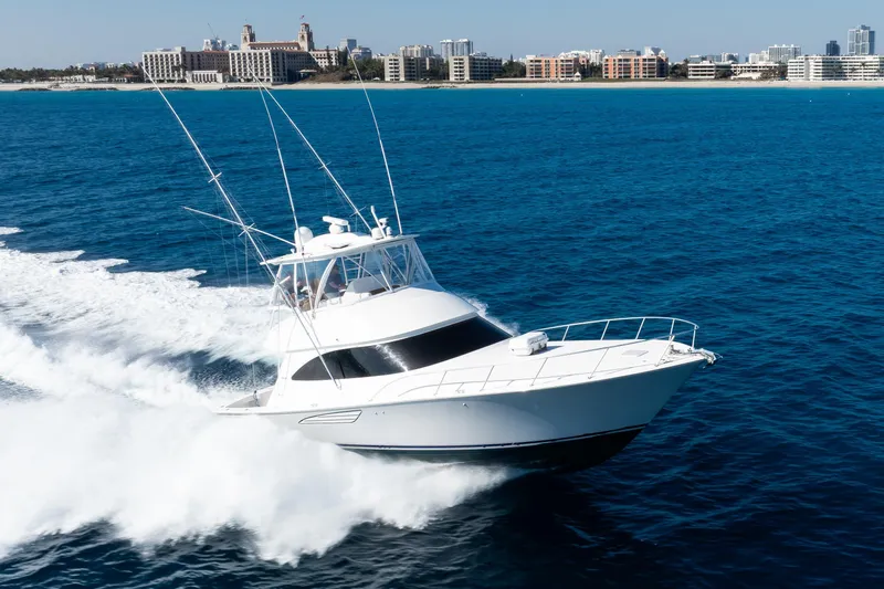 Dorothy Marie Yacht Photos Pics 2017 Viking 48 Convertible yacht cruising on blue ocean near city skyline.