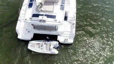 Joy Yacht Photos Pics Aerial view of a 2021 Bali 5.4 catamaran with a small boat attached.