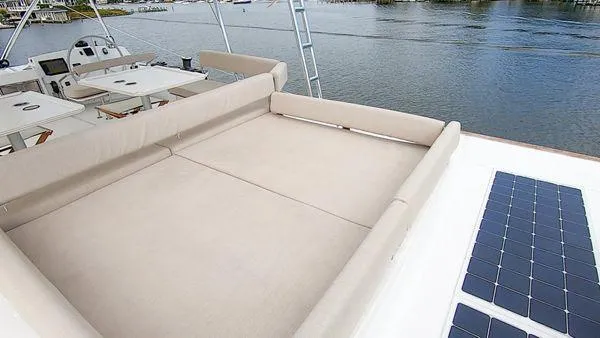 Joy Yacht Photos Pics Luxurious 2021 Bali 5.4 yacht deck with sunbed and solar panels by the water.