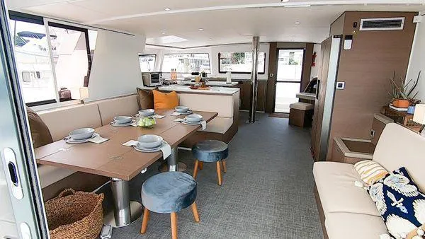 Joy Yacht Photos Pics Luxurious interior of 2021 Bali 5.4 catamaran with elegant dining area and modern decor.